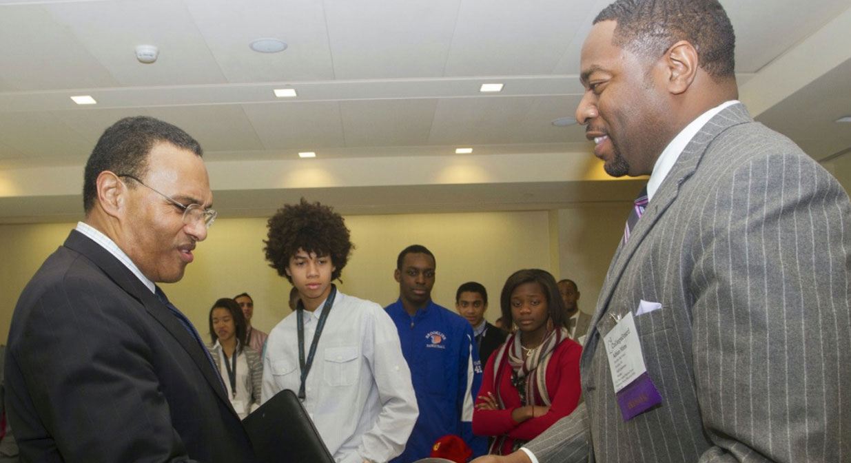 Adrian Mims shaking hands